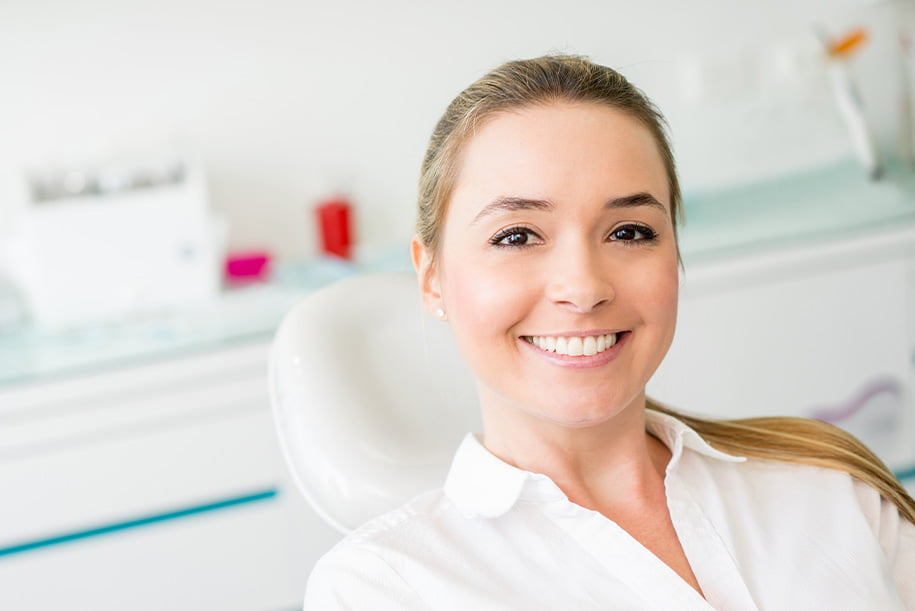 smiling woman sitting in a dental chair